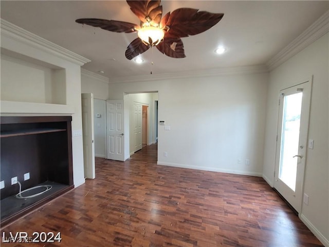 unfurnished living room with crown molding, dark wood finished floors, and baseboards