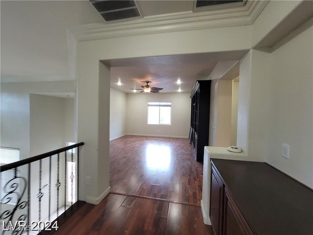 corridor with dark wood-type flooring, visible vents, and baseboards