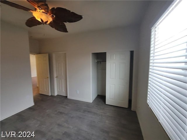 unfurnished bedroom with concrete flooring, ceiling fan, and a closet