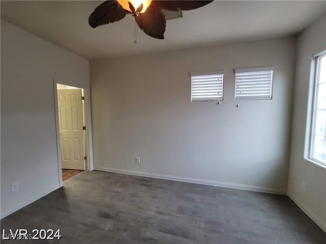 spare room featuring plenty of natural light, baseboards, and ceiling fan