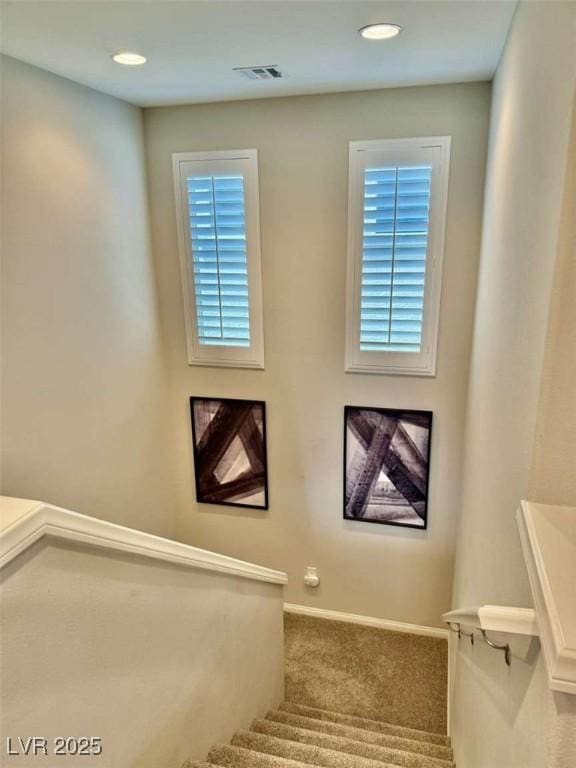 stairs with carpet, visible vents, baseboards, and recessed lighting