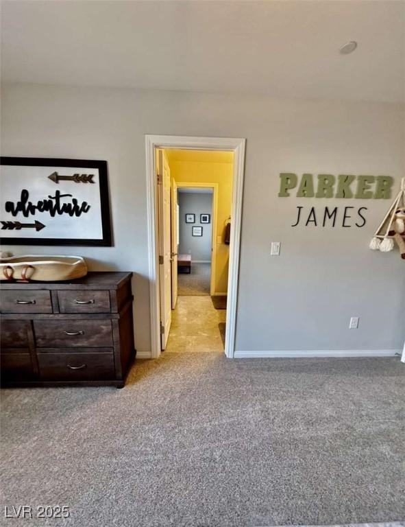 interior space featuring baseboards and light colored carpet