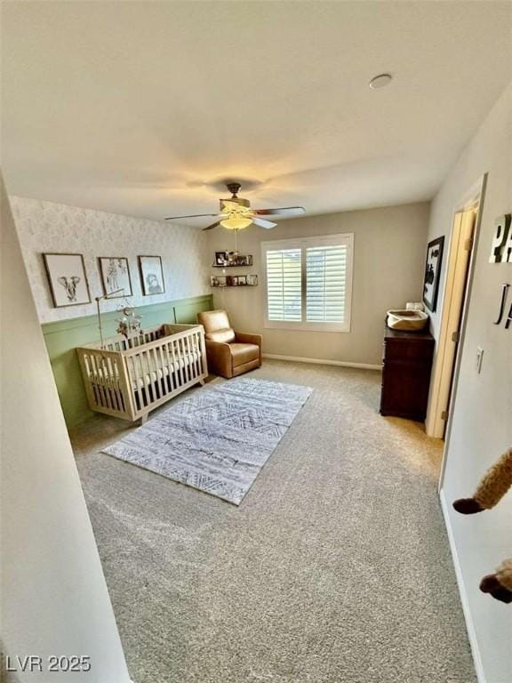 carpeted bedroom with ceiling fan and baseboards