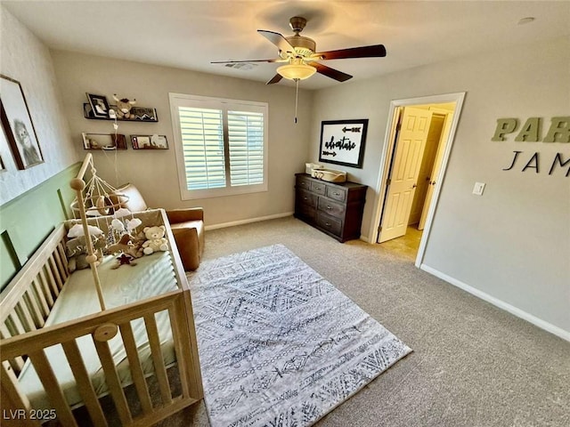 bedroom with light carpet, baseboards, and a ceiling fan