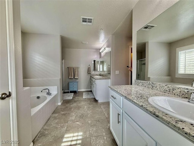 full bath with a bath, a stall shower, a sink, and visible vents