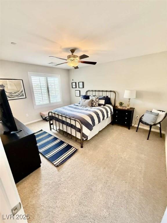 bedroom with ceiling fan, carpet flooring, and baseboards