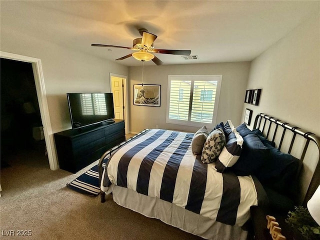 carpeted bedroom featuring a ceiling fan and visible vents