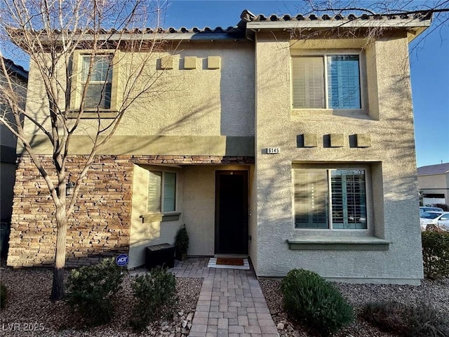 view of front of property with a tiled roof and stucco siding