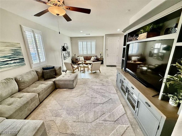 living room featuring light tile patterned floors, a ceiling fan, and recessed lighting