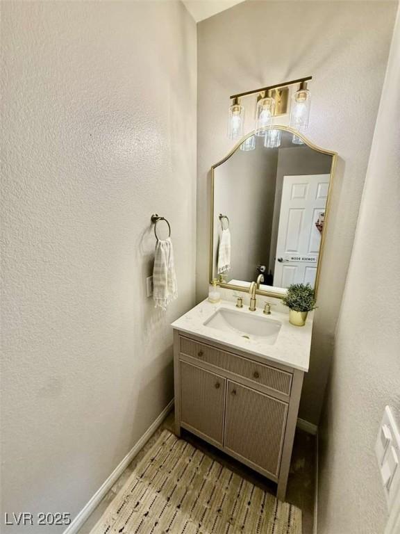 bathroom featuring vanity and baseboards