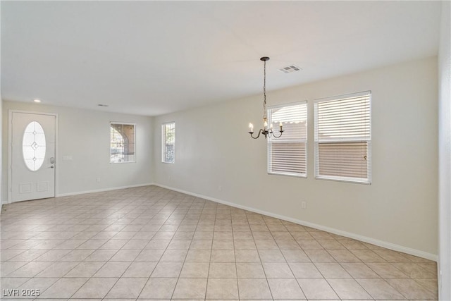 foyer entrance with light tile patterned floors, baseboards, visible vents, and a chandelier