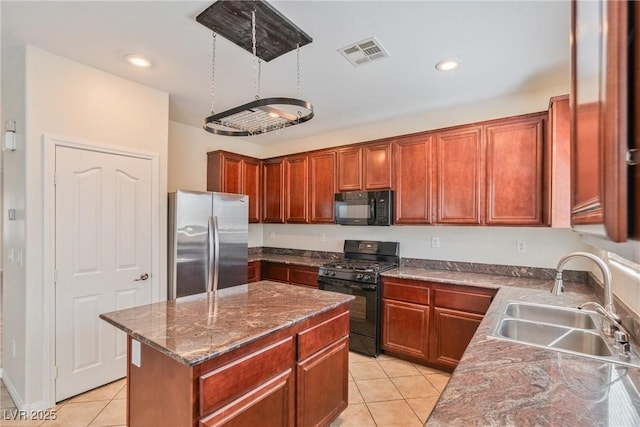 kitchen with light tile patterned floors, visible vents, a kitchen island, a sink, and black appliances