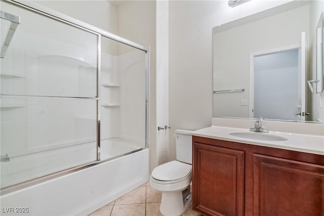 full bath featuring bath / shower combo with glass door, vanity, toilet, and tile patterned floors