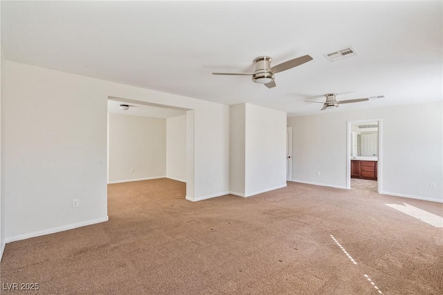 spare room featuring carpet, baseboards, visible vents, and ceiling fan