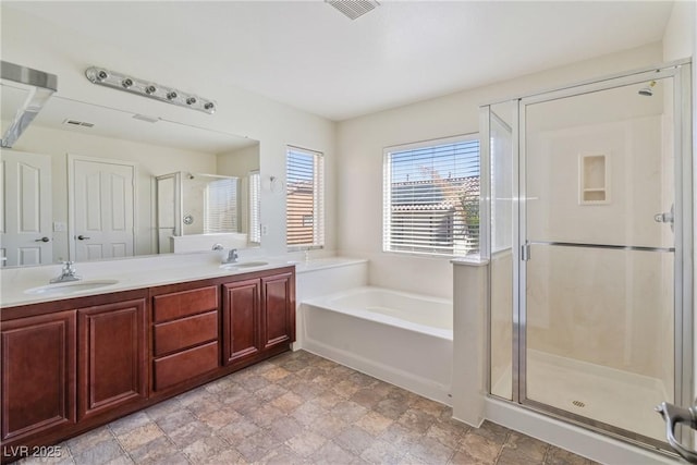 bathroom with a garden tub, a sink, visible vents, double vanity, and a stall shower