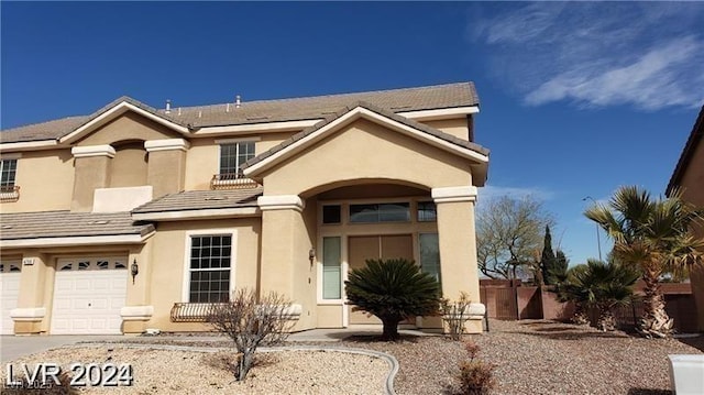 view of front facade featuring driveway, an attached garage, and stucco siding