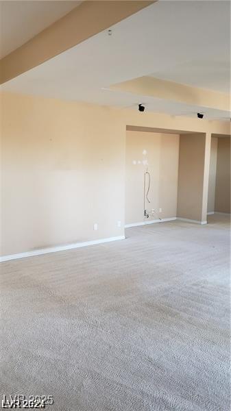 empty room with carpet flooring and baseboards