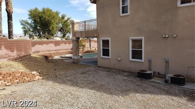 view of home's exterior featuring a fenced backyard, central AC unit, and stucco siding