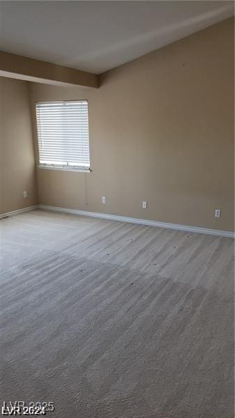 unfurnished room with baseboards