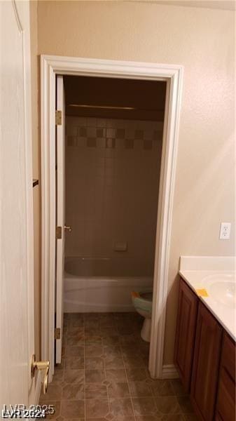 bathroom with shower / washtub combination, tile patterned flooring, vanity, and toilet