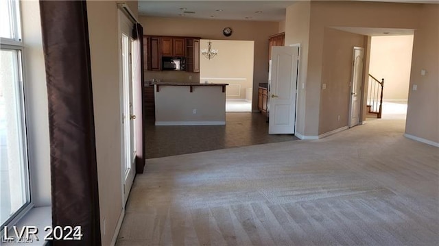 interior space with stairs, light colored carpet, baseboards, and an inviting chandelier