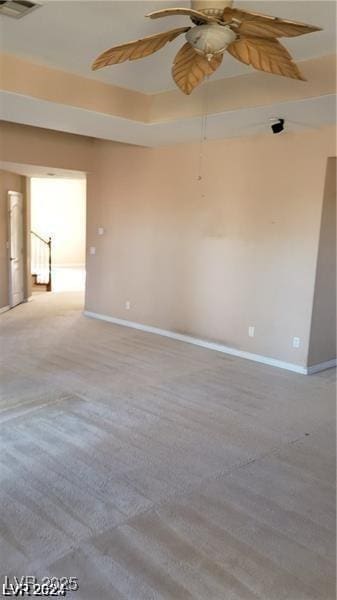 unfurnished room featuring visible vents, ceiling fan, and baseboards