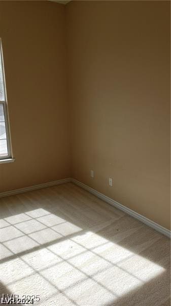 unfurnished room with baseboards