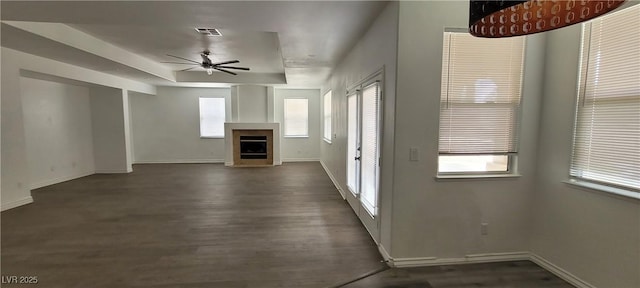 4798 Luna Ridge Ct, Las Vegas, NV 89129 - unfurnished living room featuring a ceiling fan, dark wood-style flooring, a fireplace, and baseboards