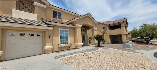 4798 Luna Ridge Ct, Las Vegas, NV 89129 - mediterranean / spanish home featuring stucco siding, a tiled roof, driveway, and an attached garage