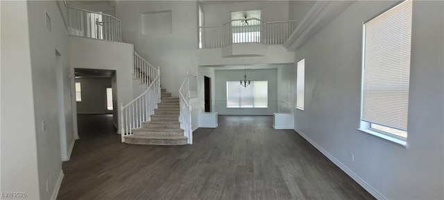 4798 Luna Ridge Ct, Las Vegas, NV 89129 - foyer featuring baseboards, dark wood-style floors, stairway, a towering ceiling, and a chandelier