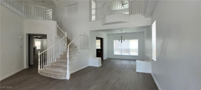 4798 Luna Ridge Ct, Las Vegas, NV 89129 - entrance foyer with stairs, wood finished floors, a high ceiling, and baseboards