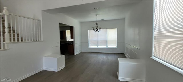 4798 Luna Ridge Ct, Las Vegas, NV 89129 - unfurnished dining area with a chandelier, dark wood-style floors, and baseboards