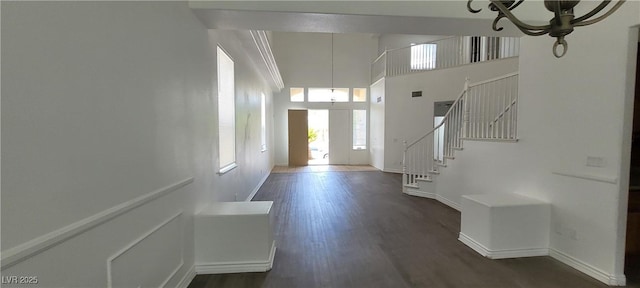 4798 Luna Ridge Ct, Las Vegas, NV 89129 - entryway with a chandelier, stairs, wood finished floors, baseboards, and a high ceiling