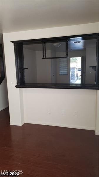 interior details featuring baseboards and wood finished floors