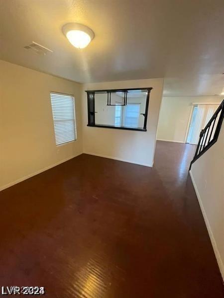 unfurnished room with baseboards