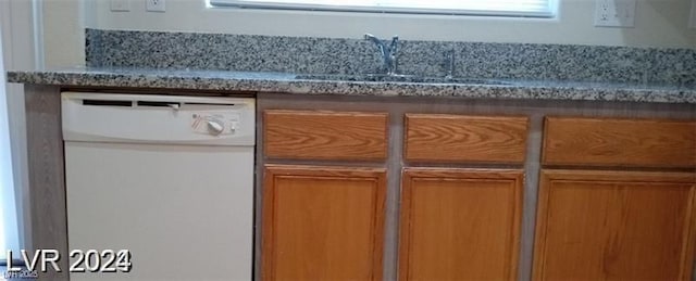 interior details featuring dishwasher and a sink