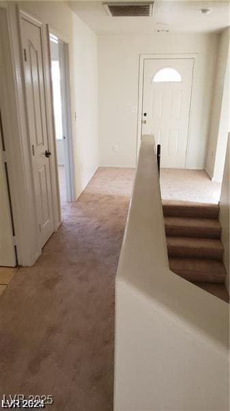 corridor with visible vents and light carpet