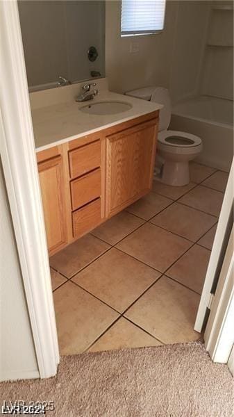 bathroom featuring toilet, vanity, and tile patterned floors