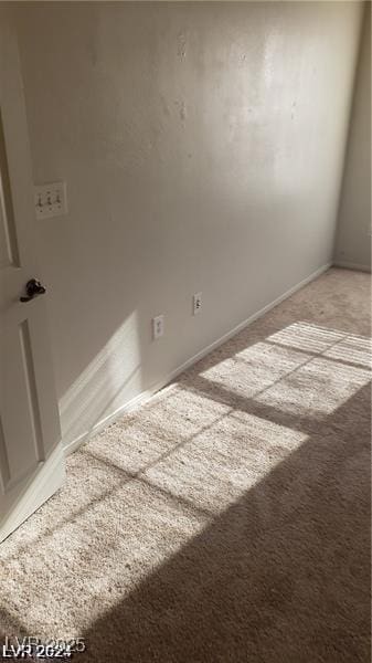 spare room featuring light carpet