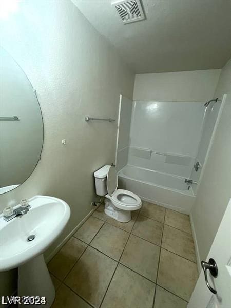 full bathroom featuring toilet, visible vents, baseboards,  shower combination, and tile patterned floors