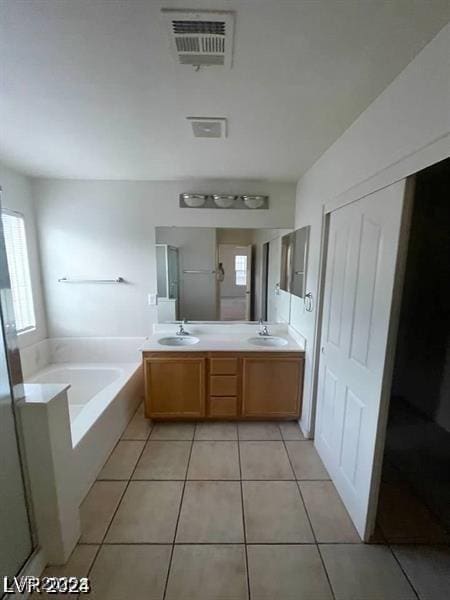 full bathroom with tile patterned flooring, visible vents, a sink, and a bath