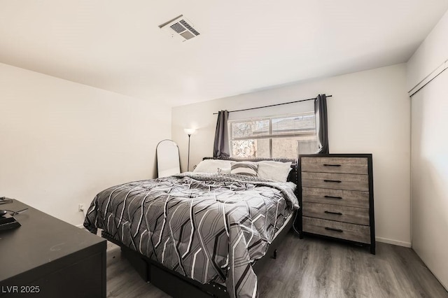 bedroom featuring dark wood-style floors and visible vents