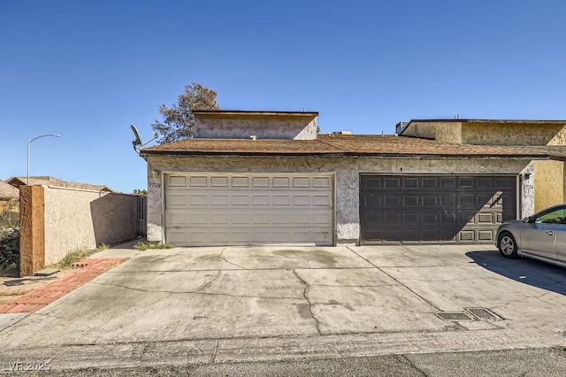 exterior space with fence and concrete driveway