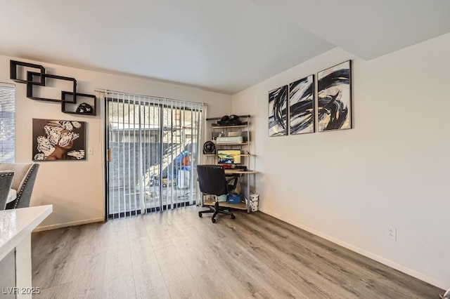 home office featuring baseboards and wood finished floors