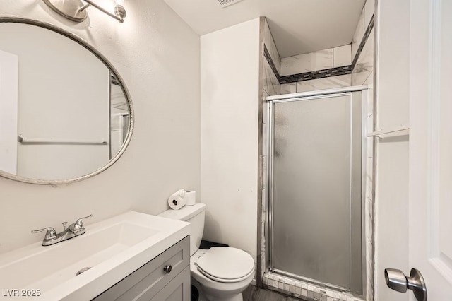 full bathroom featuring visible vents, toilet, a shower stall, and vanity