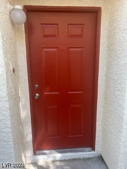 property entrance featuring stucco siding