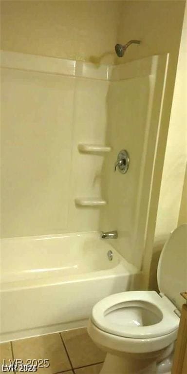 bathroom with shower / washtub combination, toilet, and tile patterned floors