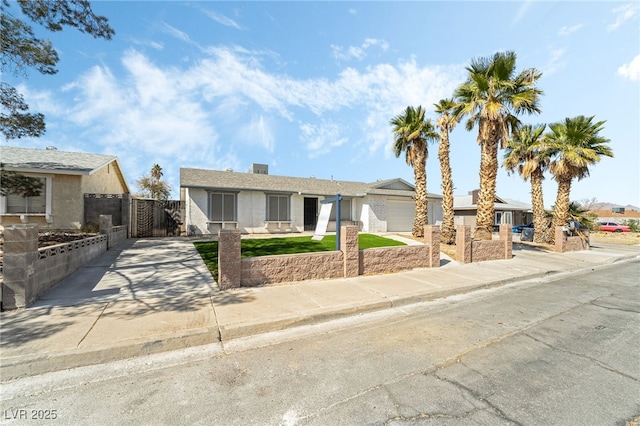 single story home featuring concrete driveway, a gate, fence, and a garage