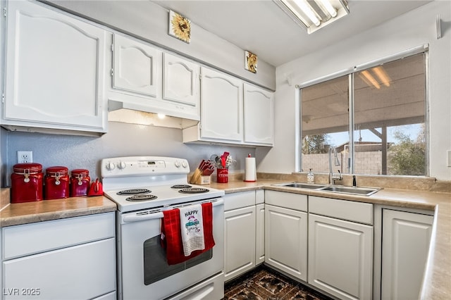 kitchen featuring white range with electric stovetop, white cabinetry, light countertops, and a sink