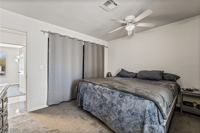 bedroom featuring visible vents, baseboards, a ceiling fan, and carpet flooring